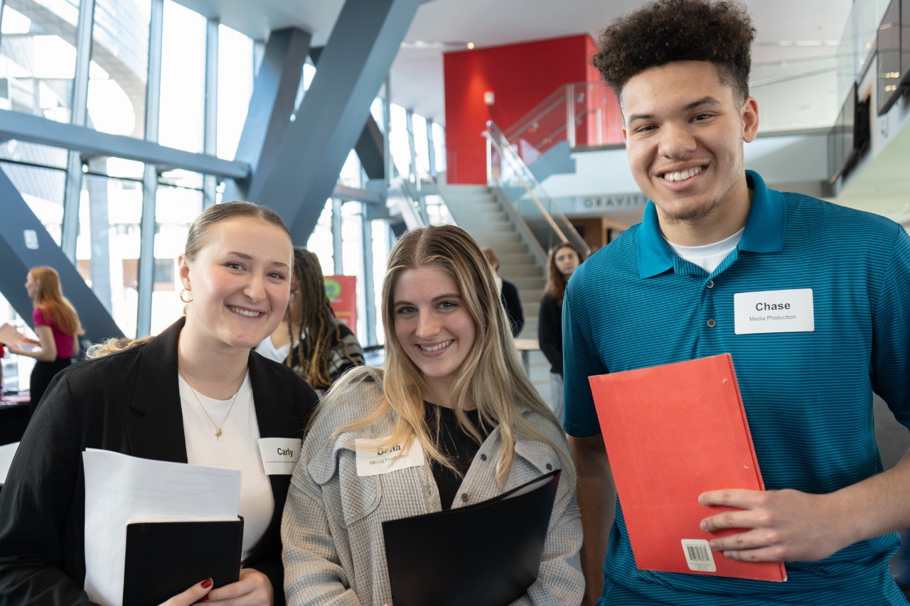 Three students pose for a photograph during CCM Media Production's career day.