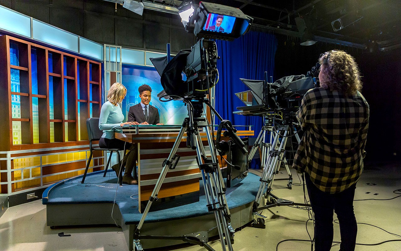 Two students film a broadcast in the Bartlett Television Center 