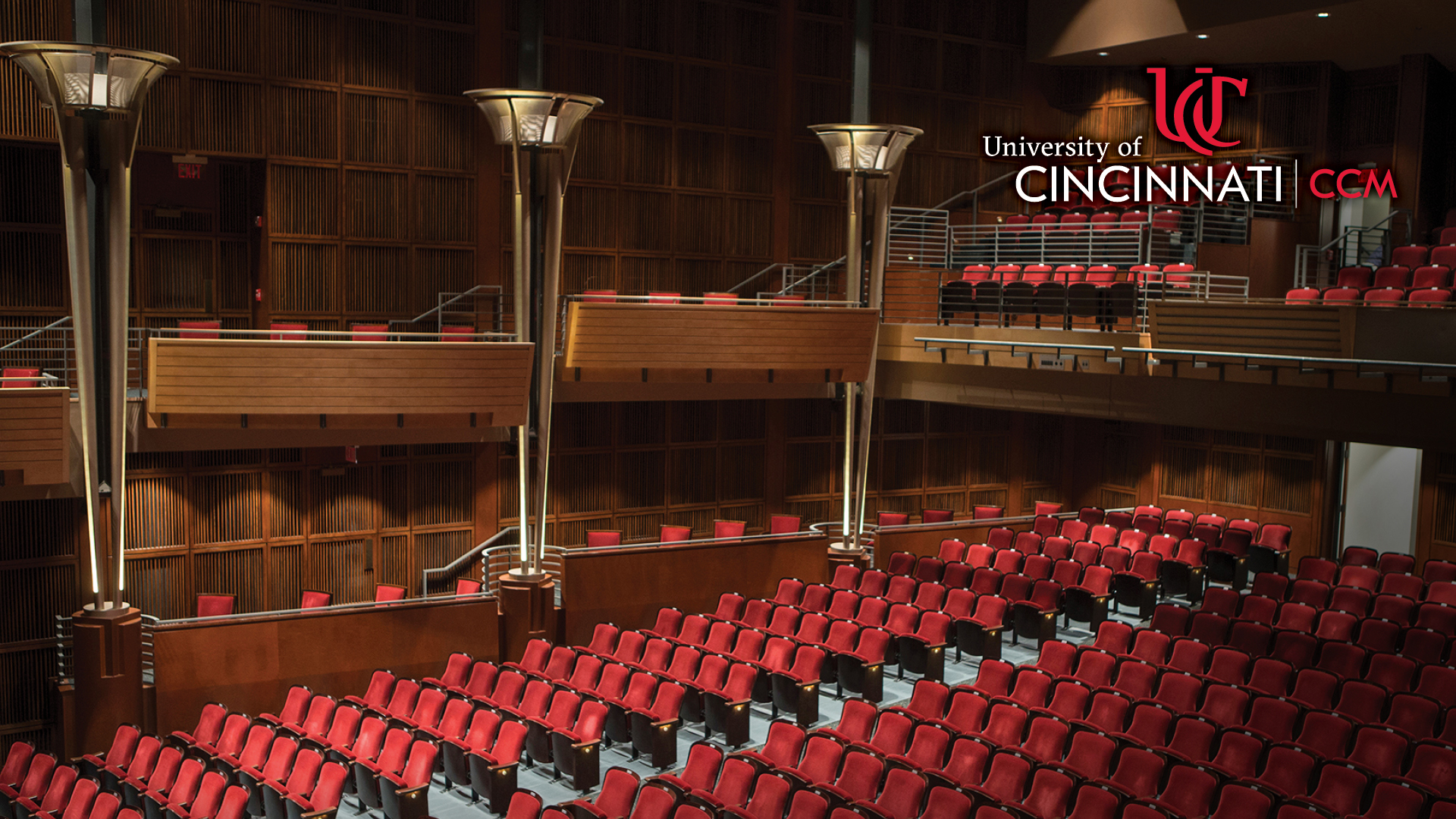 A CCM-branded webinar background featuring a photo of the seats of CCM's Corbett Auditorium.